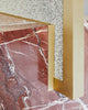 Cube base detail image of standing mirror with red jasper marble base and brass mirror frame, speckled beige rubber back.