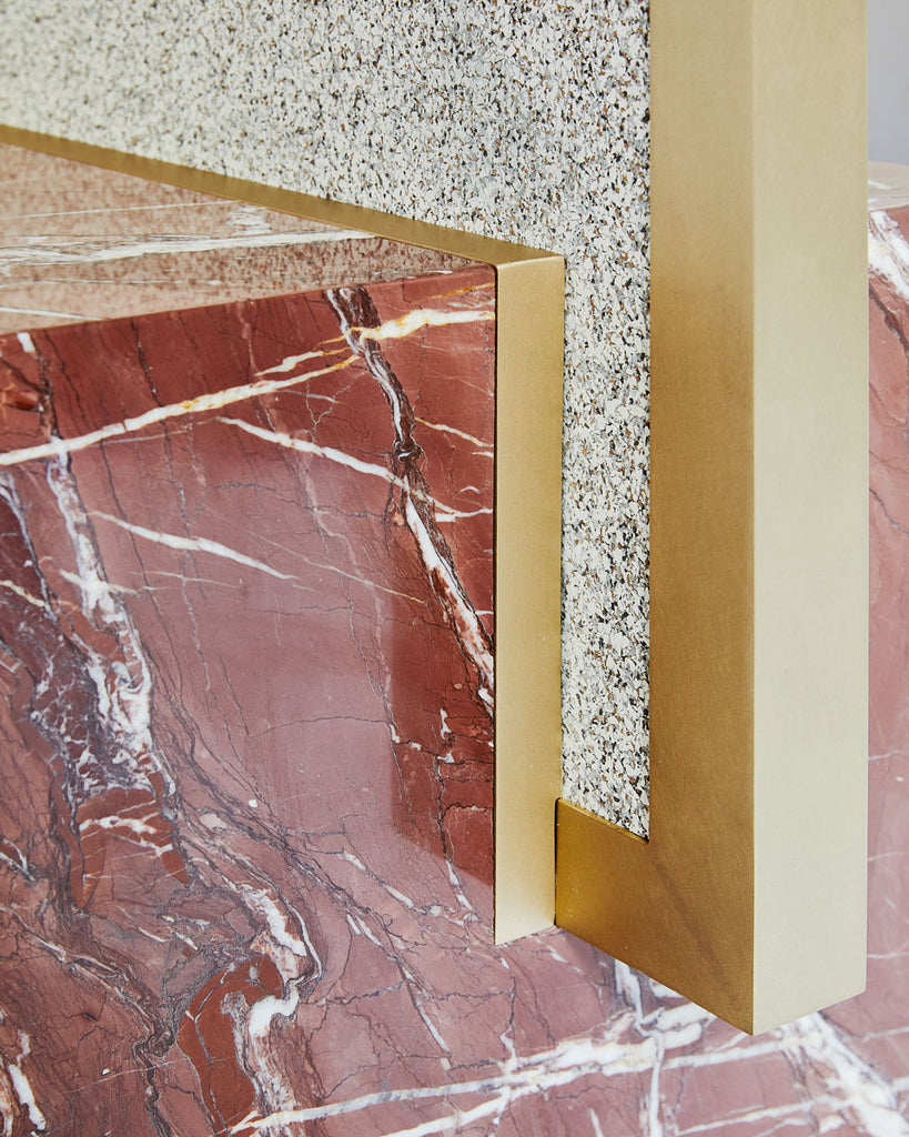 Cube base detail image of standing mirror with red jasper marble base and brass mirror frame, speckled beige rubber back.