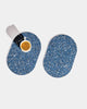 Two capsule speckled blue rubber trivets on white surface. One trivet has a white espresso cup on it.